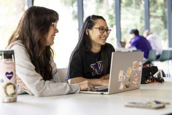 smiling students at computer