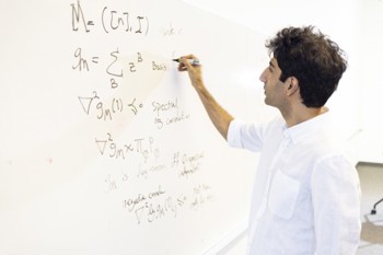 a person writing math models on a whiteboard